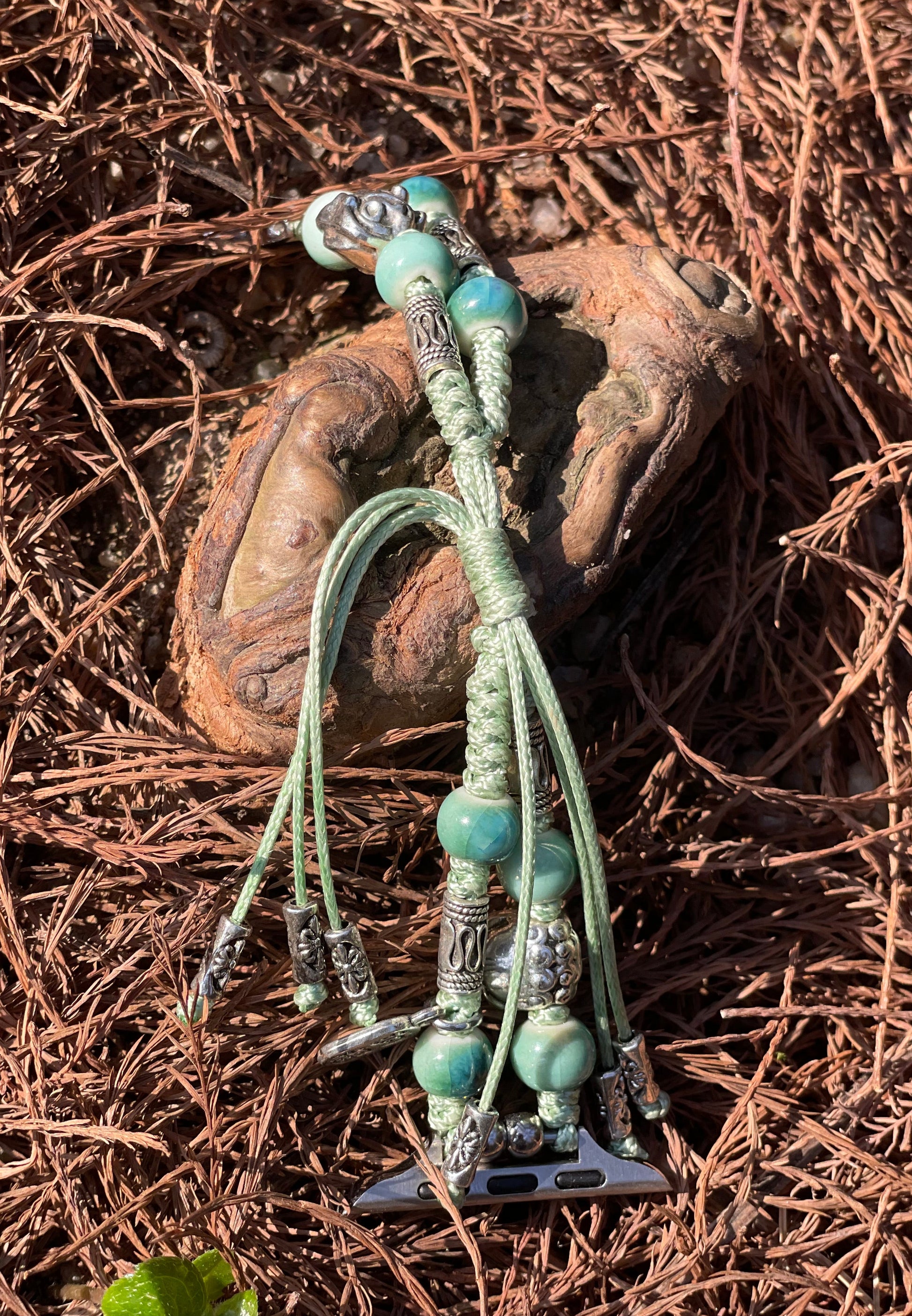 Bracelet-style watch band with turquoise beads on a textured brown surface