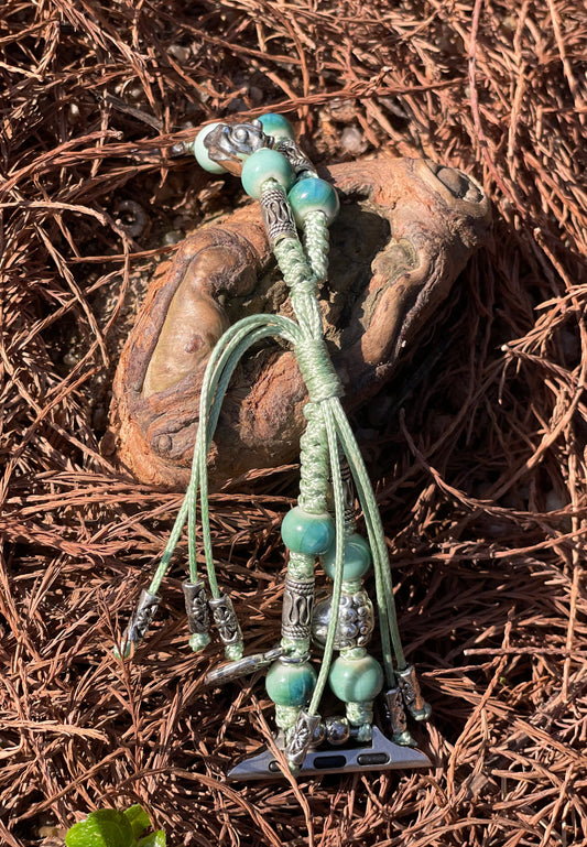 Bracelet-style watch band with turquoise beads on a textured brown surface